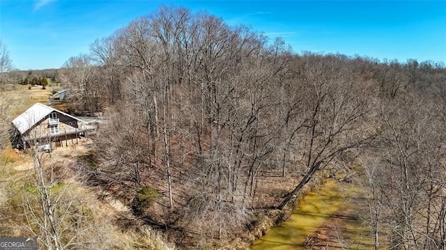 bird's eye view featuring a wooded view