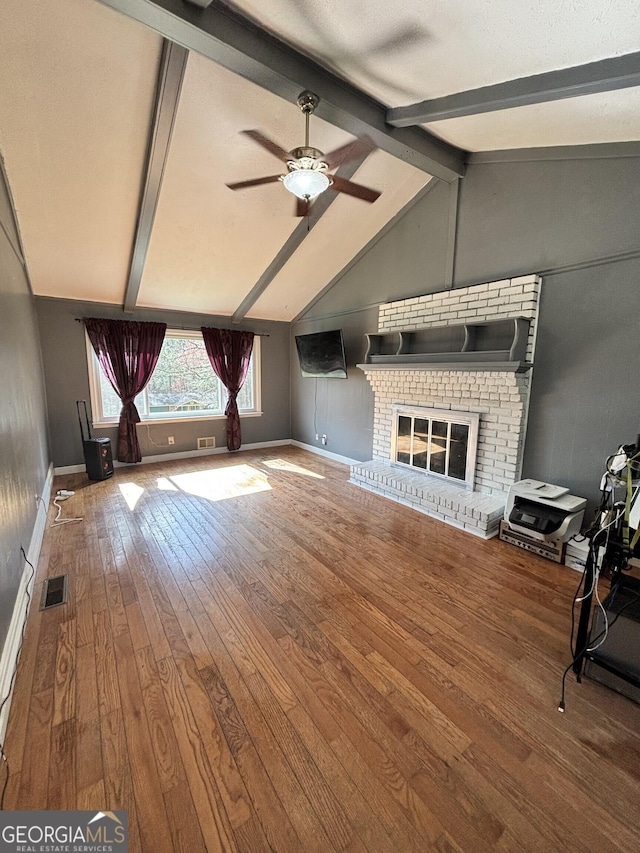 unfurnished living room featuring wood-type flooring, a ceiling fan, vaulted ceiling with beams, and visible vents