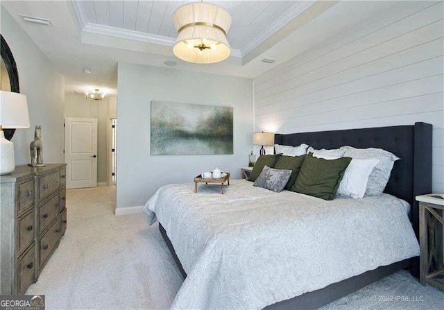 bedroom with a raised ceiling, crown molding, and light colored carpet