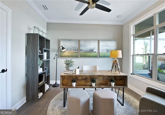 home office with baseboards, visible vents, ceiling fan, wood finished floors, and crown molding