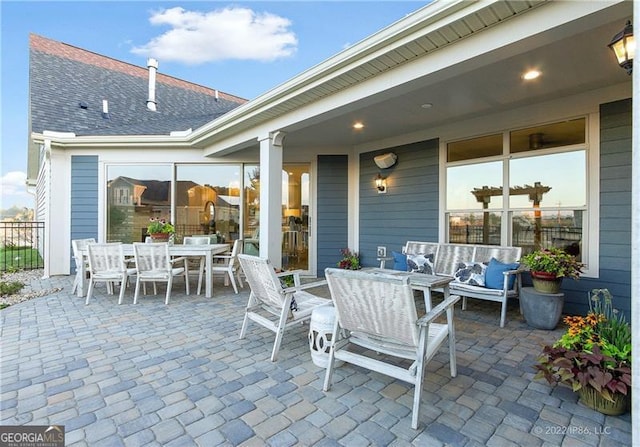 view of patio / terrace featuring outdoor dining space, fence, and an outdoor living space