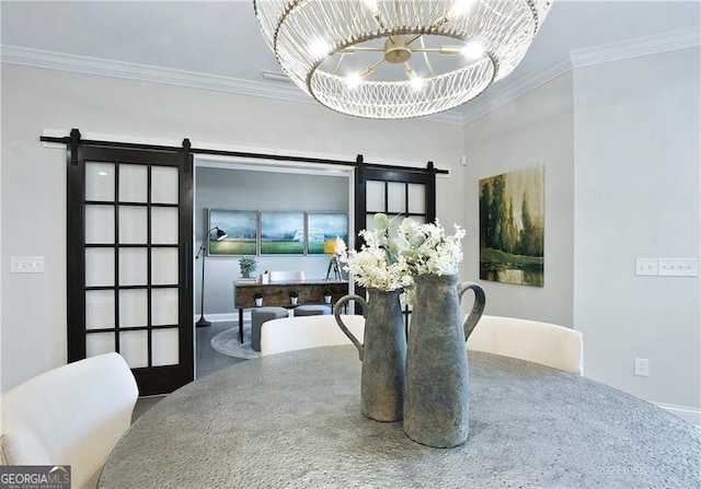 dining area featuring ornamental molding, an inviting chandelier, and a barn door