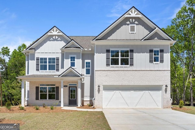 view of front of house featuring board and batten siding, concrete driveway, brick siding, and a garage