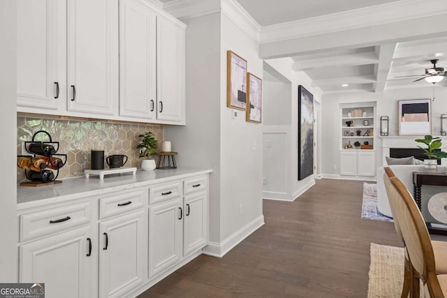 kitchen with beam ceiling, dark wood finished floors, open floor plan, coffered ceiling, and baseboards