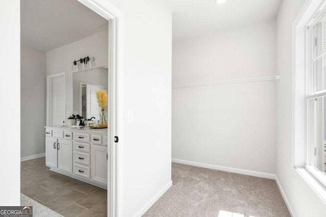 bathroom with baseboards and vanity