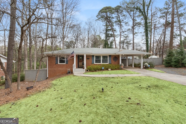 single story home featuring brick siding, fence, an attached carport, driveway, and a front lawn