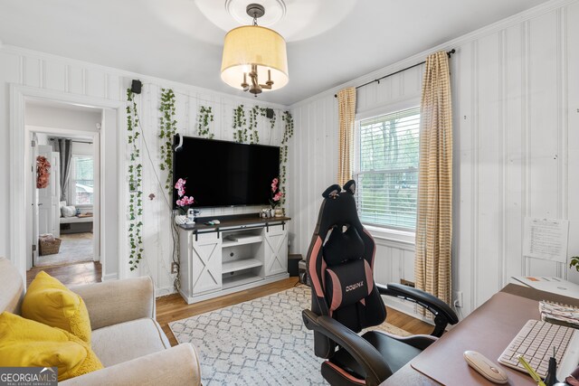 office space featuring light wood-type flooring and crown molding