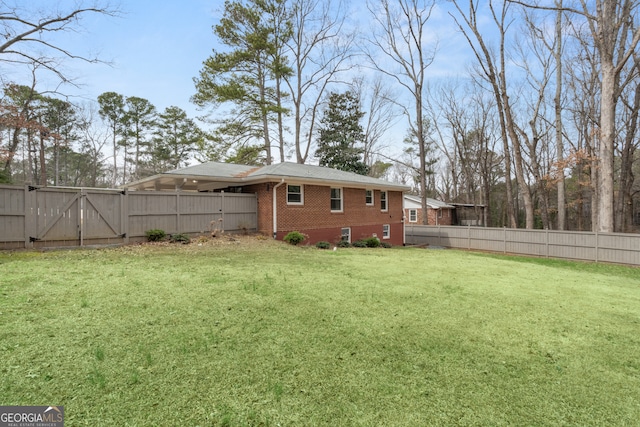 view of yard featuring a gate and a fenced backyard