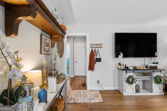 interior space featuring baseboards and wood finished floors