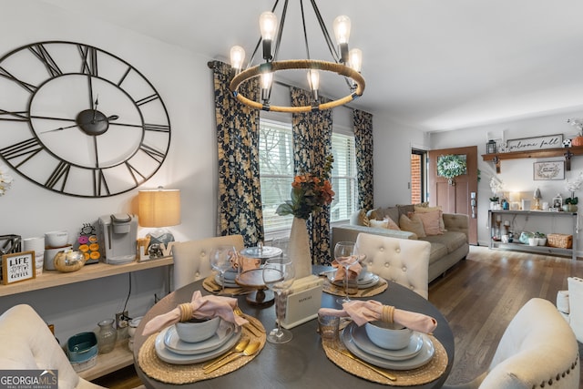 dining area with wood finished floors and a notable chandelier