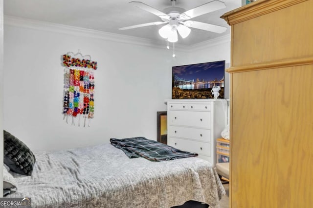 bedroom with ornamental molding and a ceiling fan