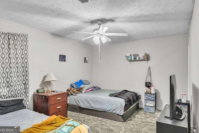 bedroom with a textured ceiling, ceiling fan, carpet flooring, and baseboards