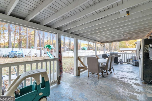 view of patio featuring outdoor dining space, a playground, a fenced backyard, and area for grilling