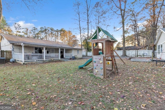 view of jungle gym with a lawn, a fenced backyard, and central air condition unit