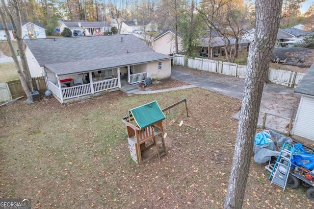 back of property featuring a porch, central AC, and fence