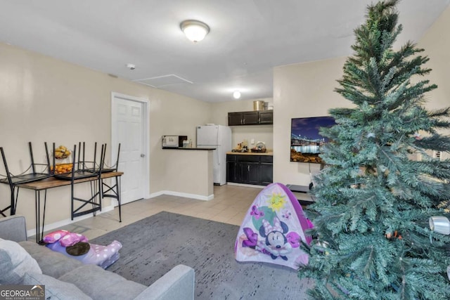 living area with light tile patterned floors and baseboards