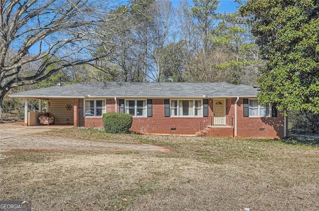 ranch-style home with a carport, brick siding, crawl space, and a front yard