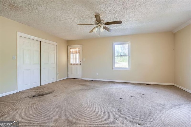 unfurnished bedroom with carpet floors, multiple windows, and baseboards