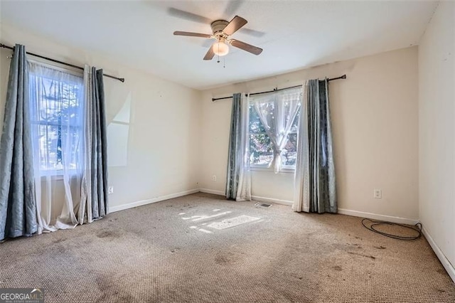 spare room with ceiling fan, baseboards, and carpet flooring