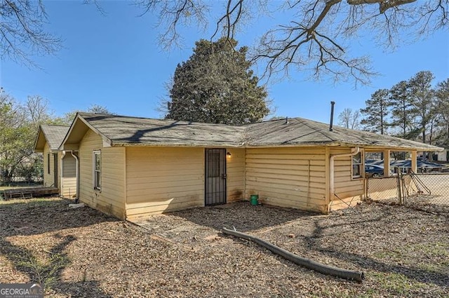 rear view of house with fence