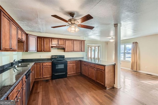 kitchen featuring a sink, black electric range, stainless steel dishwasher, brown cabinets, and dark wood finished floors