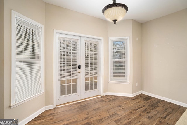 entryway featuring baseboards, dark wood-type flooring, and french doors