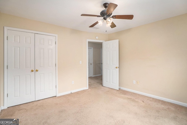 unfurnished bedroom with ceiling fan, carpet floors, a closet, and baseboards