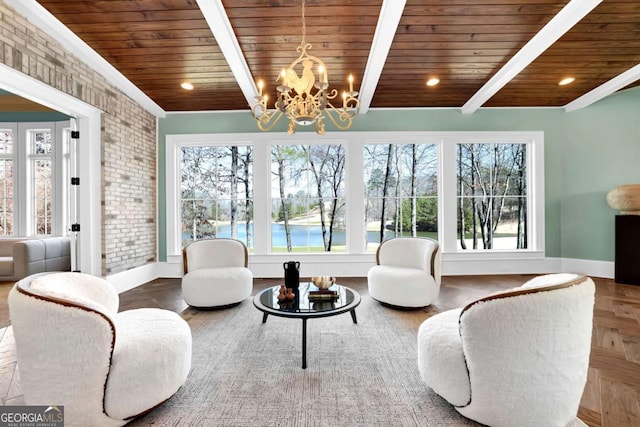 sunroom / solarium featuring beam ceiling, an inviting chandelier, wood ceiling, and a wealth of natural light