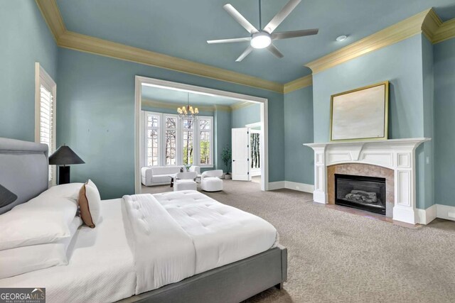 carpeted bedroom with crown molding, baseboards, and a premium fireplace