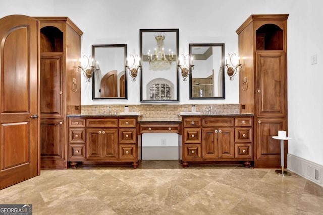 full bath with a sink, visible vents, a notable chandelier, and double vanity