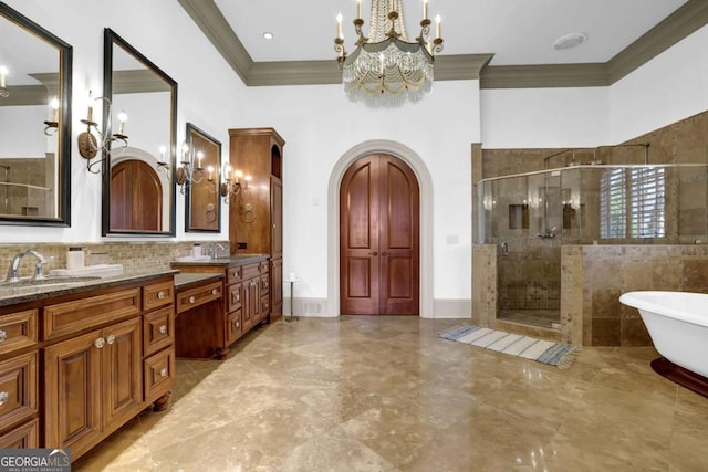 full bath featuring double vanity, a freestanding tub, ornamental molding, a sink, and a shower stall