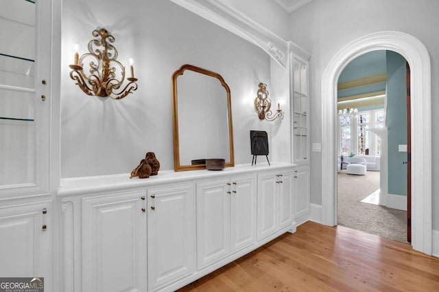 bathroom featuring a chandelier, built in features, and wood finished floors