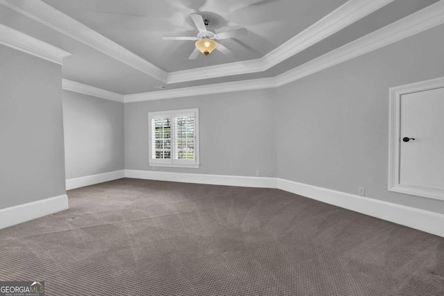 empty room featuring baseboards, crown molding, a tray ceiling, and carpet floors