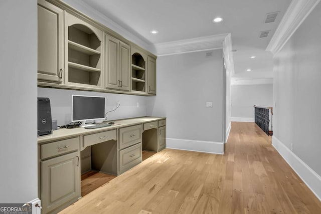 unfurnished office featuring baseboards, recessed lighting, light wood-style floors, built in desk, and crown molding