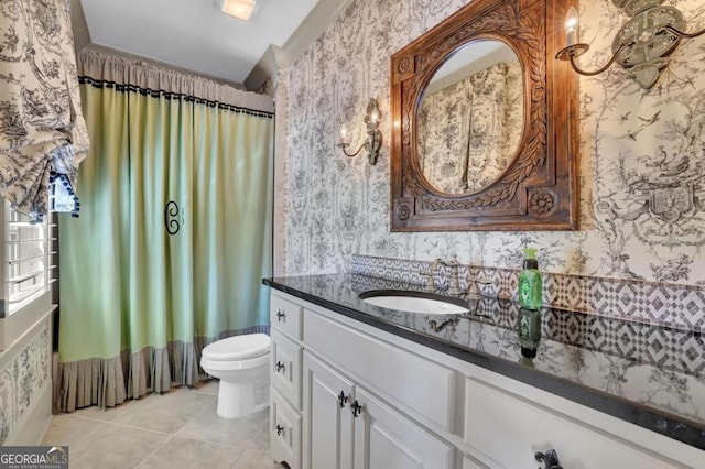 full bath featuring toilet, wallpapered walls, and vanity