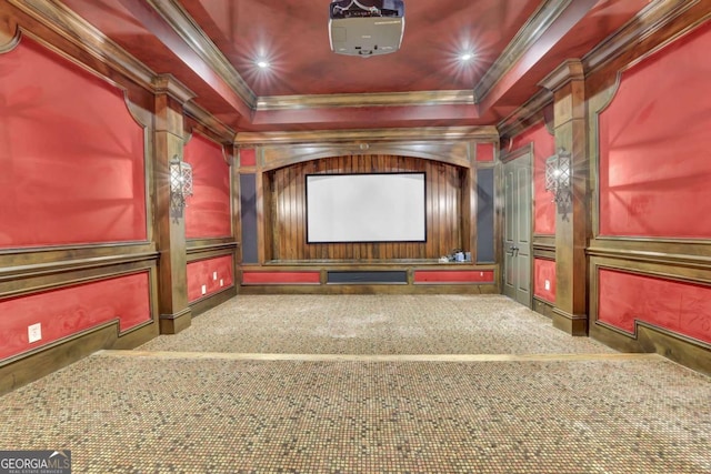 carpeted cinema featuring a decorative wall, recessed lighting, a raised ceiling, and ornamental molding