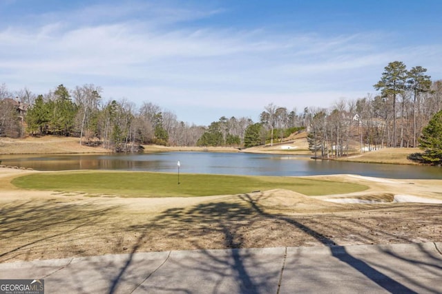 surrounding community featuring a water view and view of golf course