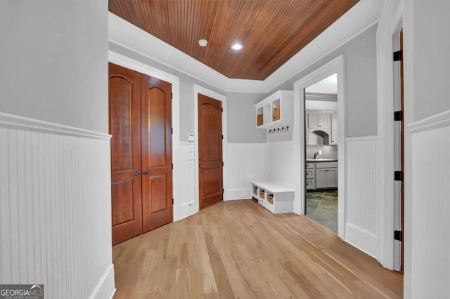 hall with wooden ceiling, light wood-style flooring, recessed lighting, and a wainscoted wall