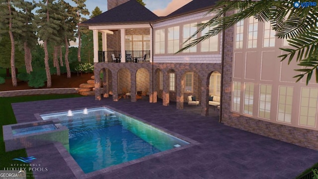 view of pool with a patio area and a pool with connected hot tub