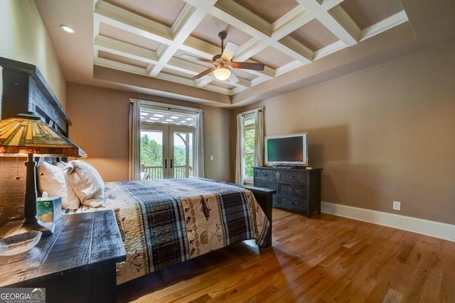 bedroom with coffered ceiling, wood finished floors, baseboards, access to exterior, and french doors