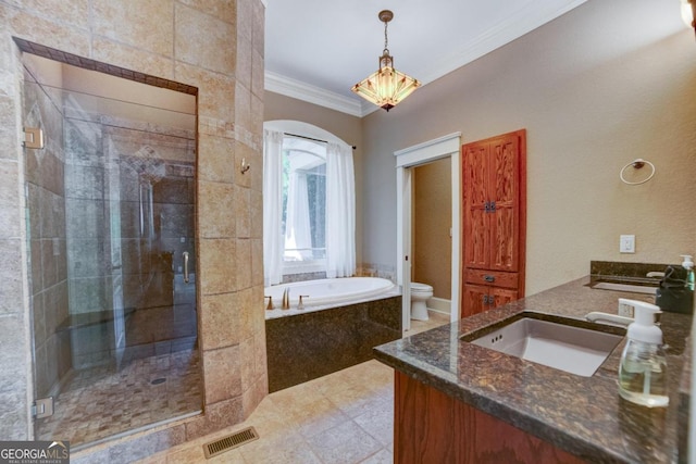 bathroom featuring crown molding, toilet, a sink, a shower stall, and a bath