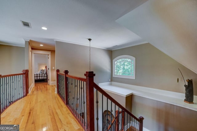 hallway with ornamental molding, recessed lighting, an upstairs landing, and wood finished floors