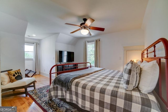 bedroom with light wood-style floors, baseboards, and a ceiling fan