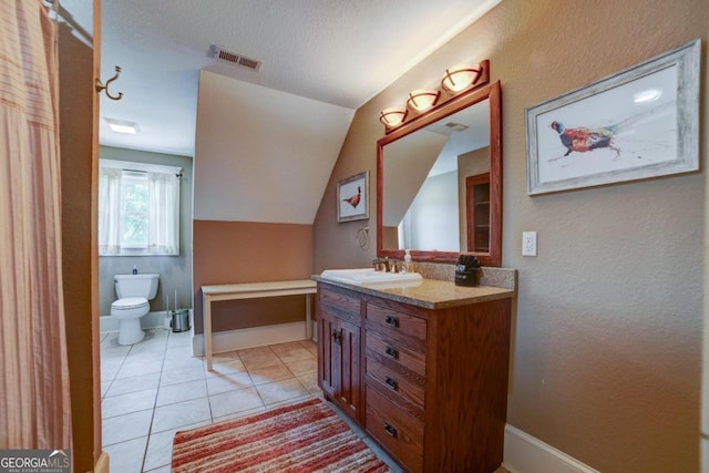 bathroom with tile patterned flooring, toilet, vanity, visible vents, and vaulted ceiling