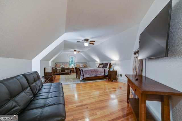 bedroom with lofted ceiling, light wood-style floors, ceiling fan, and baseboards