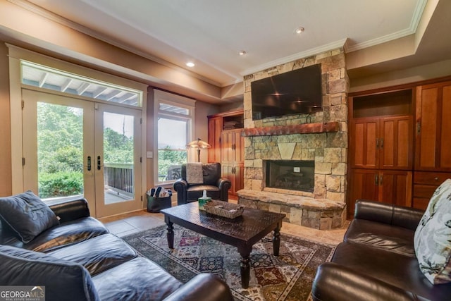 living room with french doors, ornamental molding, a fireplace, and light tile patterned flooring