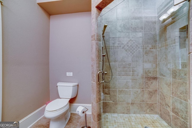 full bath with baseboards, a shower stall, toilet, and tile patterned floors