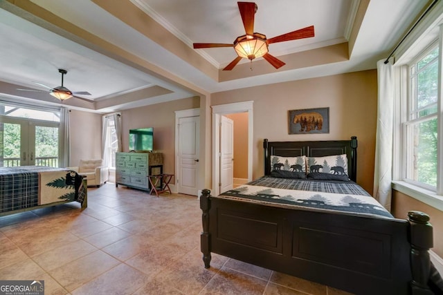 bedroom featuring baseboards, ornamental molding, a raised ceiling, and french doors