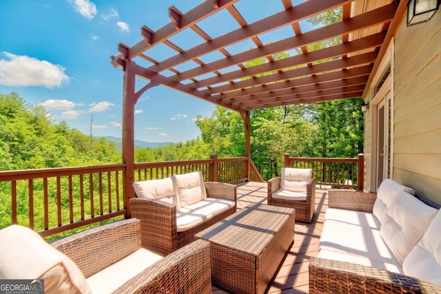 wooden deck featuring an outdoor hangout area and a pergola