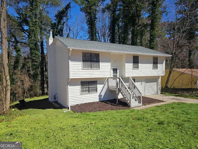 view of front facade with a garage, a front yard, concrete driveway, and a chimney